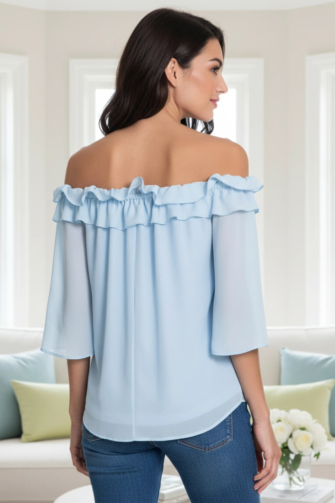 Lennon Blouse in motion, highlighting the off-shoulder neckline and light movement