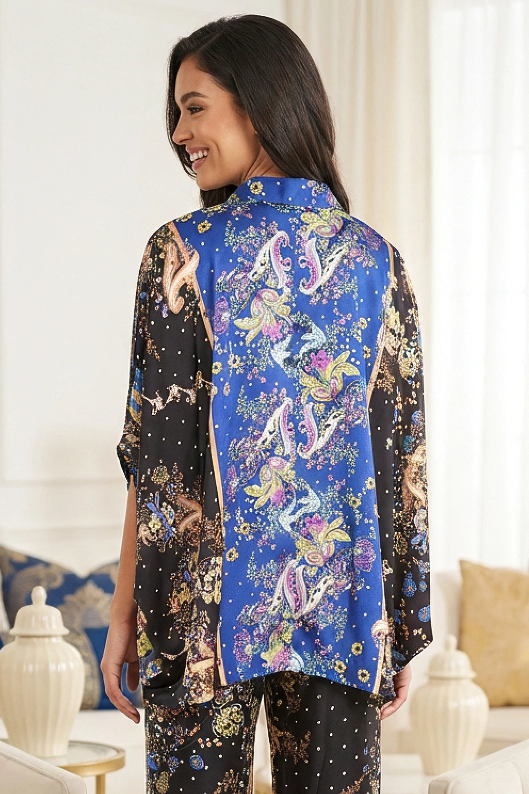 Back view of draped kimono top with fluid satin movement.
