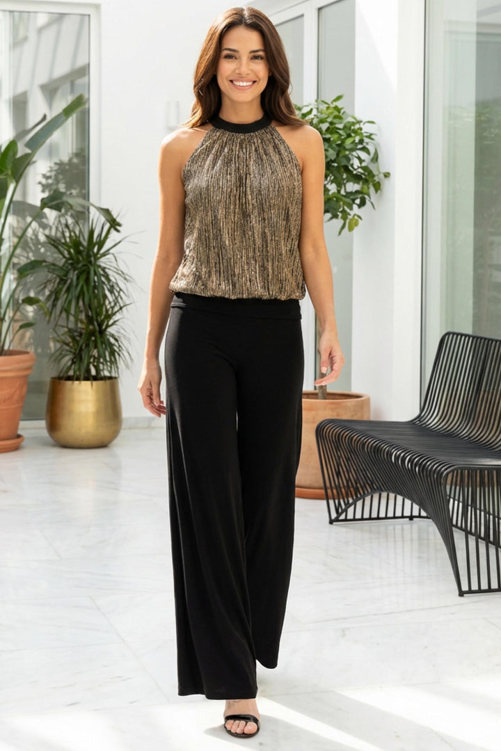 Supreme halter top in motion paired with black pants.