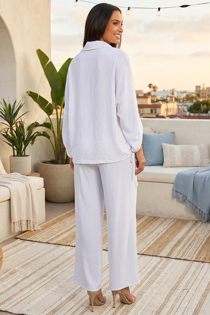 Kore Pant Back View – White styled for a coastal afternoon or resort outing.