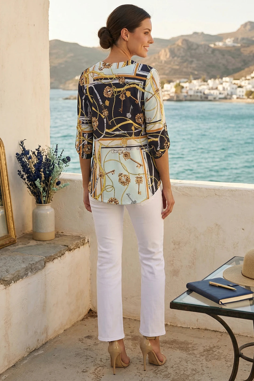 Nova Top styled with white pants for resort daytime and night look lifestyle back view